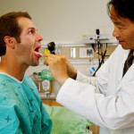 Doctor examining throat